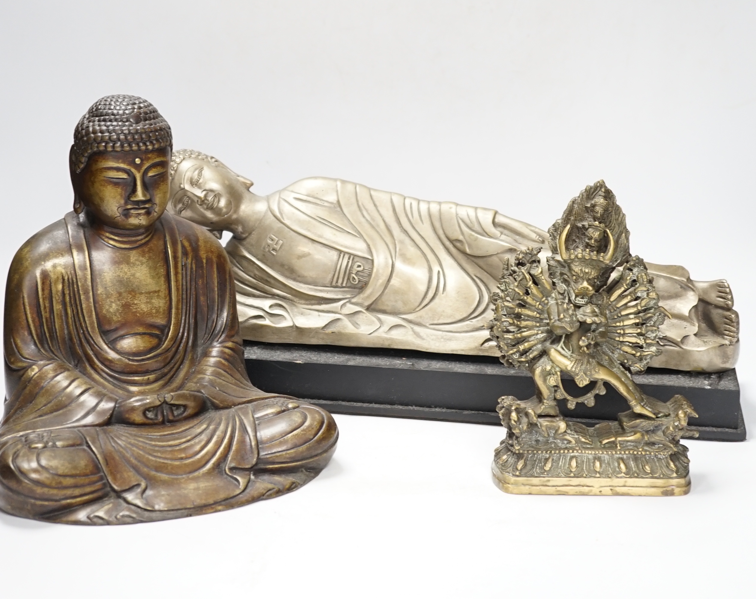 Three bronze and other metal figures of the Buddha and a Tibetan figure of Yamantaka, tallest 21.5cm